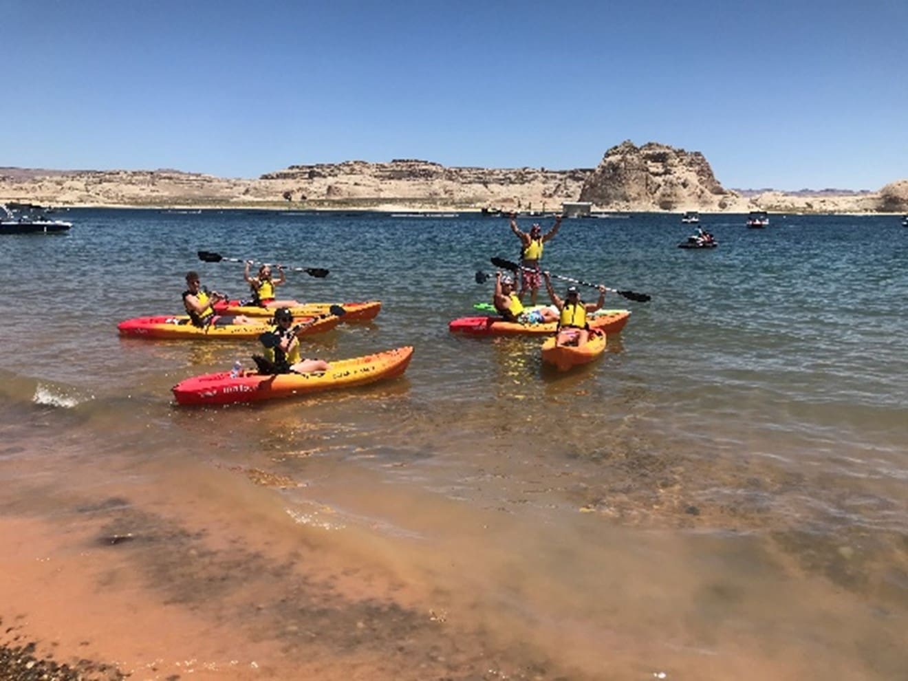 A group of people in kayaks on the water.