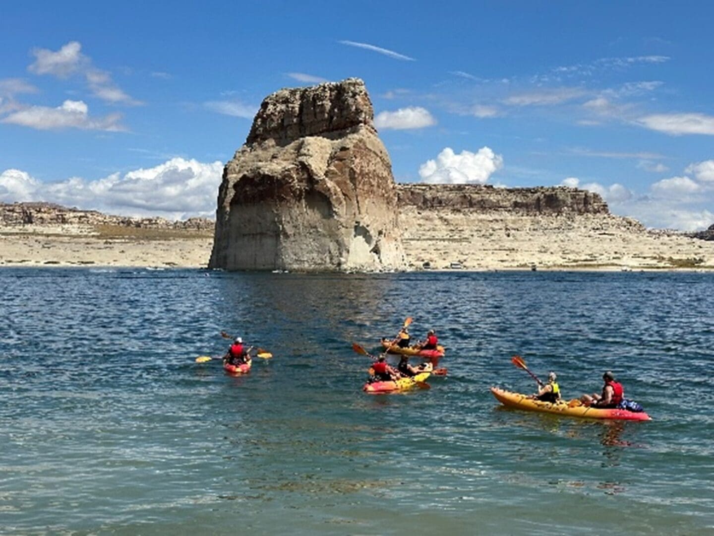 A group of people in kayaks on the water.